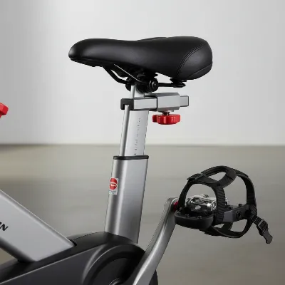 Close-up of Schwinn IC4 dual-sided pedals and adjustable seat.